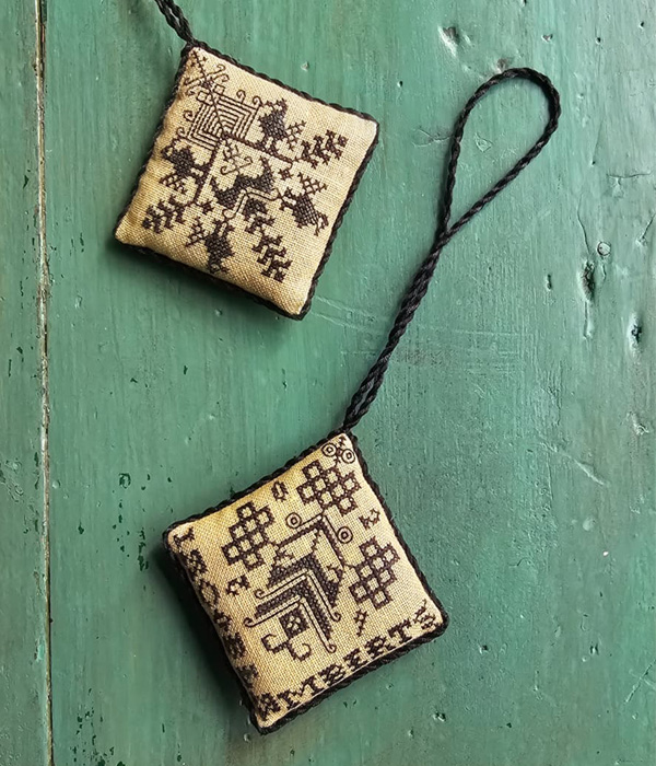 the Two Corner Pinkeep is an original cross-stitch design inspired by 17th century Friisan sampler, charted by Modern Folk Embroidery